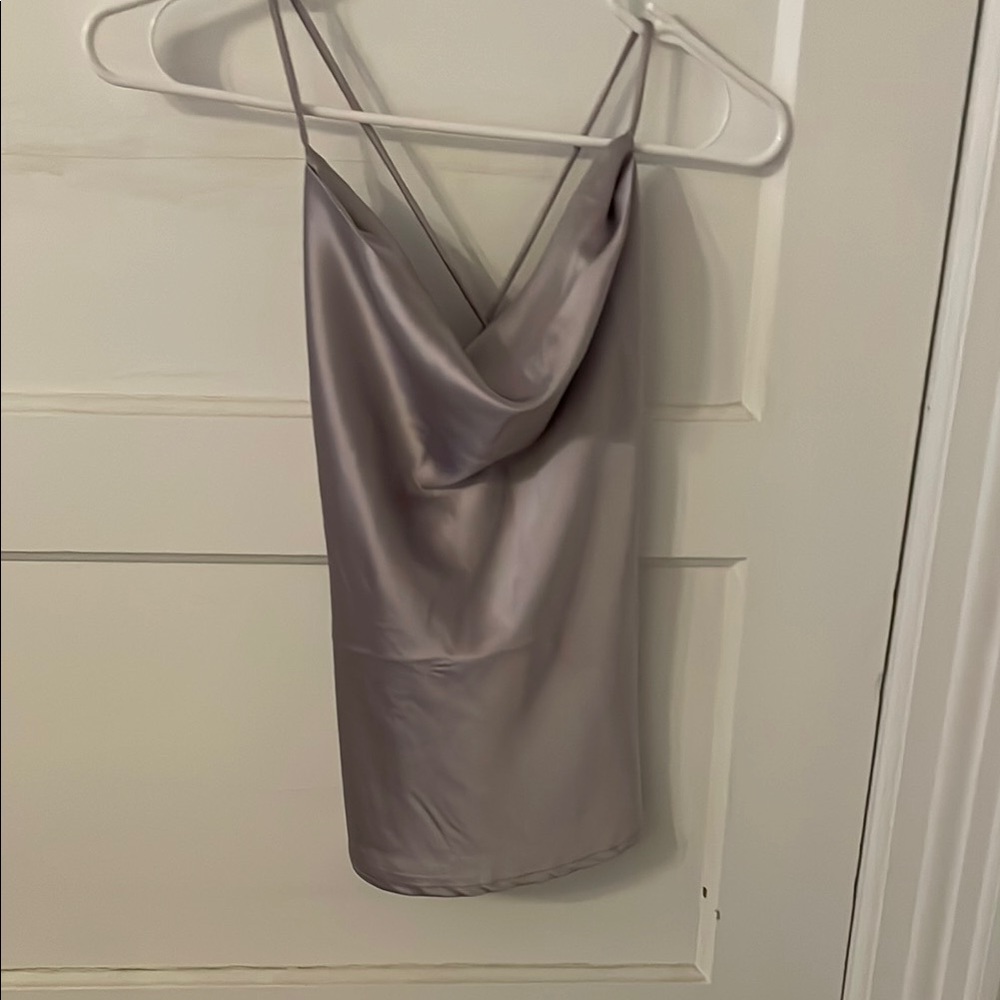 Grayish purple color tank top. Slits on the sides. Tie up backing.